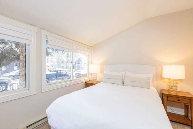 On the first level, the first bedroom features a queen bed.