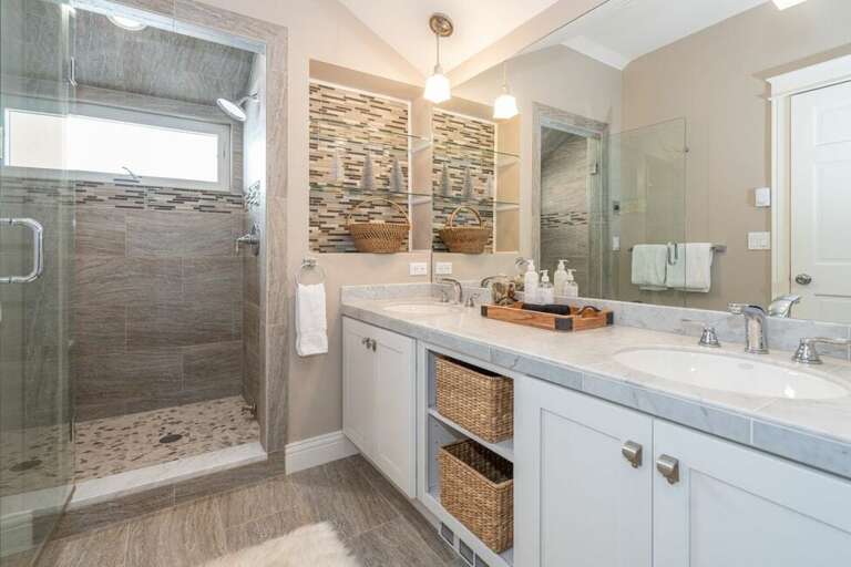 The primary bathroom offers a shower and double vanity.