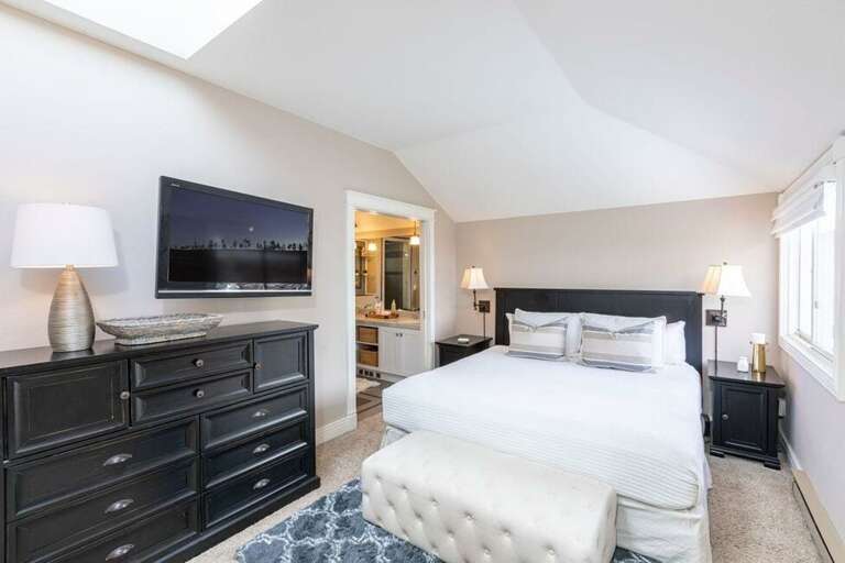 The spacious primary bedroom features a king bed and ensuite bathroom.