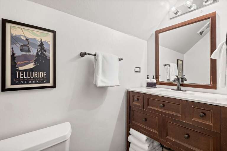 The ensuite bathroom features a single vanity and a tub/shower combo for comfort and convenience.
