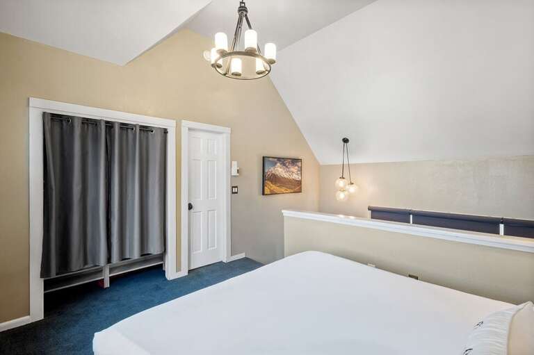 Escape to a king bedroom with ensuite bath, framed by stunning views and the gentle rhythm of a mountain creek for a peaceful, restorative getaway.