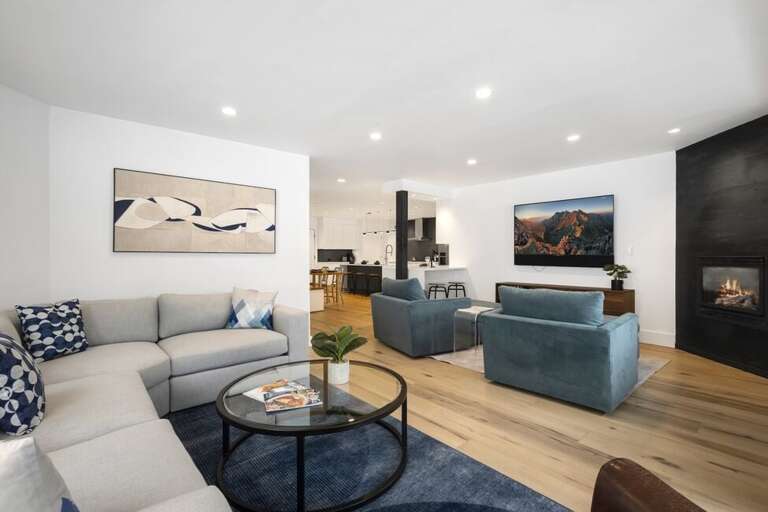 Spacious living area with TV and fireplace.