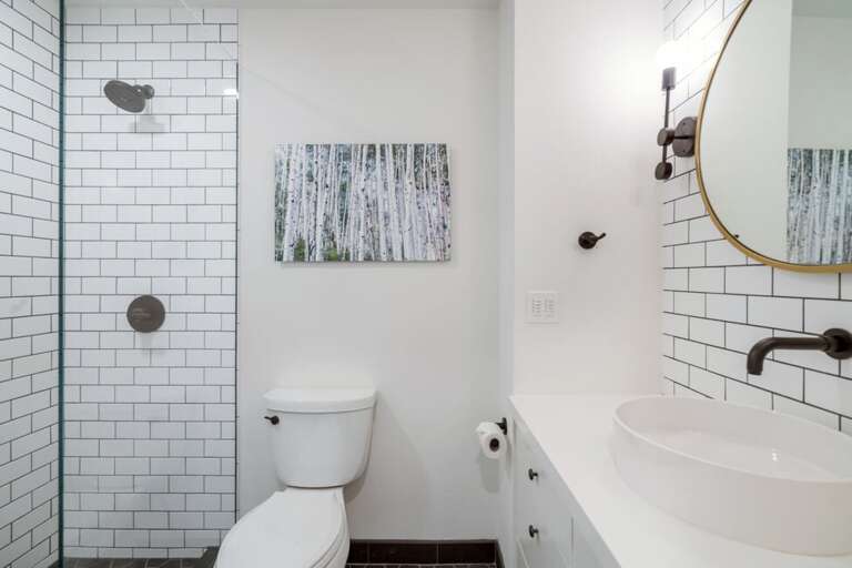 This crisp classic white bathroom with contemporary accents has all you need.