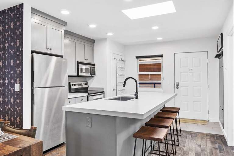 This unit offers a large spacious kitchen with bar seating for four.