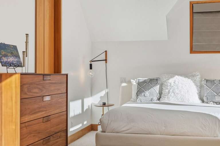 Bright and airy primary suite featuring a king bed, expansive walk-in closet, spa-inspired ensuite, and private deck with gas fireplace.