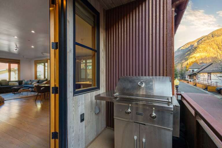 The deck, accessible from the living area, features a grill and provides the perfect space for outdoor cooking and entertaining.