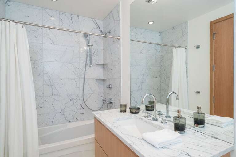 The en suite of the downstairs king guest bedroom has a combined shower and tub.