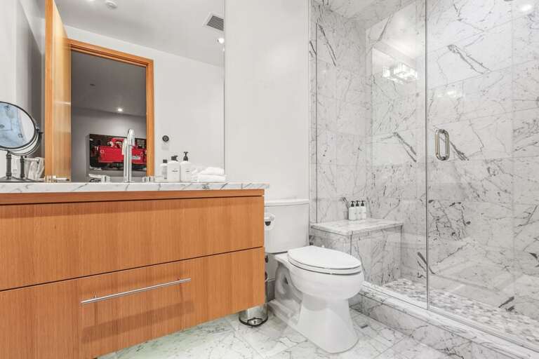 Ensuite for the media/fourth bedroom features single vanity and step in shower.