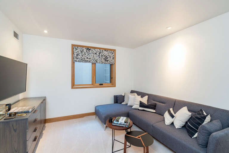 The fourth bedroom is a media room/bedroom. The sofa folds down to be a large sleeper sofa, potentially sleeping 2-3 kids.