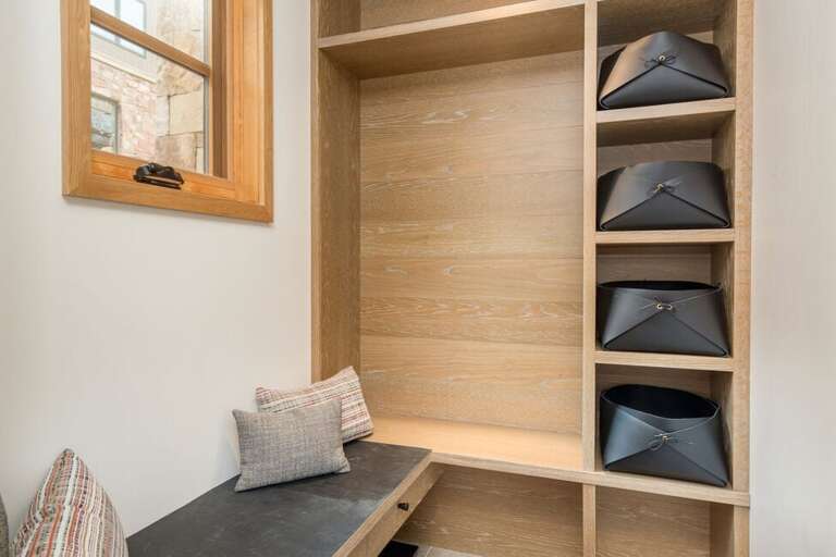 Ironwood A - the entryway on the street level features a bench seat and cubbies for storage of hats, goggles, gloves etc.