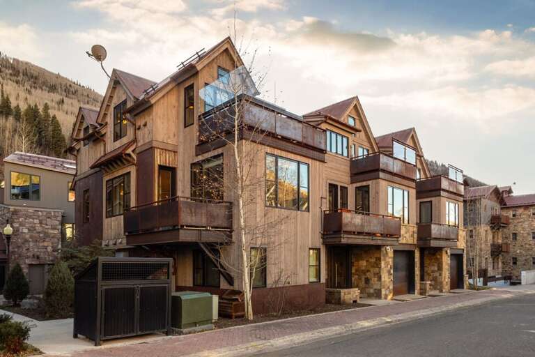 A luxurious four-bedroom, multi-level home in a quiet neighborhood featuring garage parking, private decks, hot tub, and stunning views.