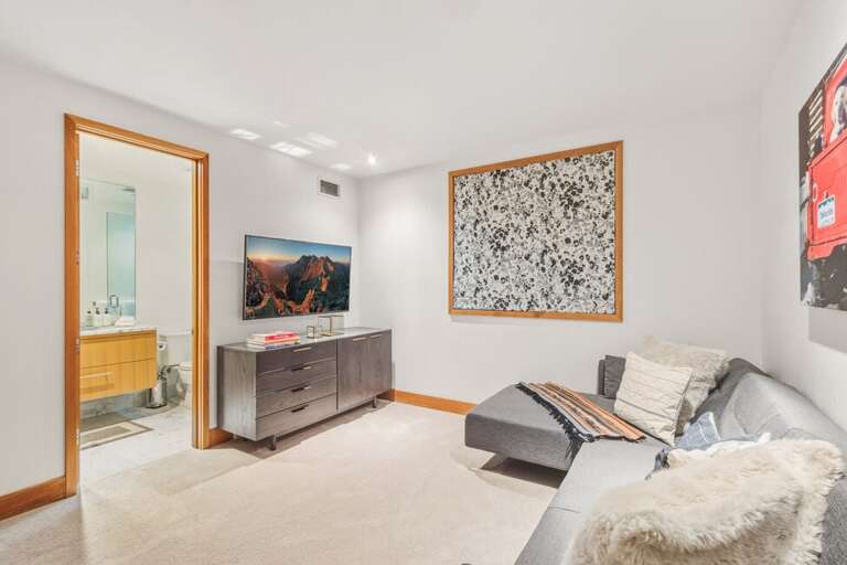 The media room, serving as a fourth bedroom, features an en suite bathroom and a cozy sleeper sofa that comfortably accommodates 2–3 children.