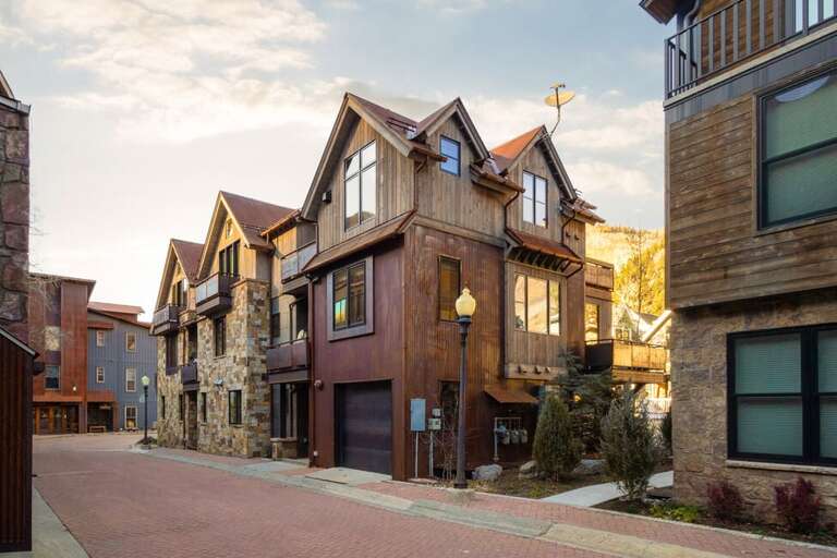 This multi-level home features four bedrooms in a quiet residential neighborhood, with garage parking for a small car, private decks, a hot tub, and stunning mountain views.