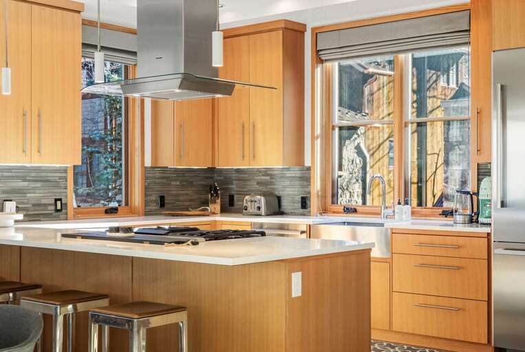 The oversized kitchen island provides comfortable seating for four, perfect for relaxed morning meals.