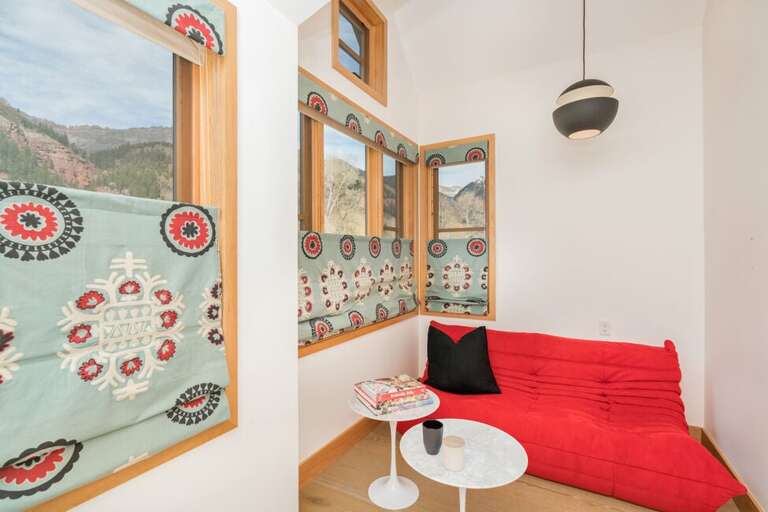 There is a small nook off of the primary suite with a futon, flat screen and wet bar.