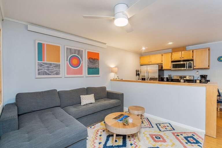 Colorful open living area with large cozy couch, and entertainment area for lounging after a fun day exploring Telluride. Colorful open living area with large cozy couch, and entertainment area for lounging after a fun day exploring Telluride.