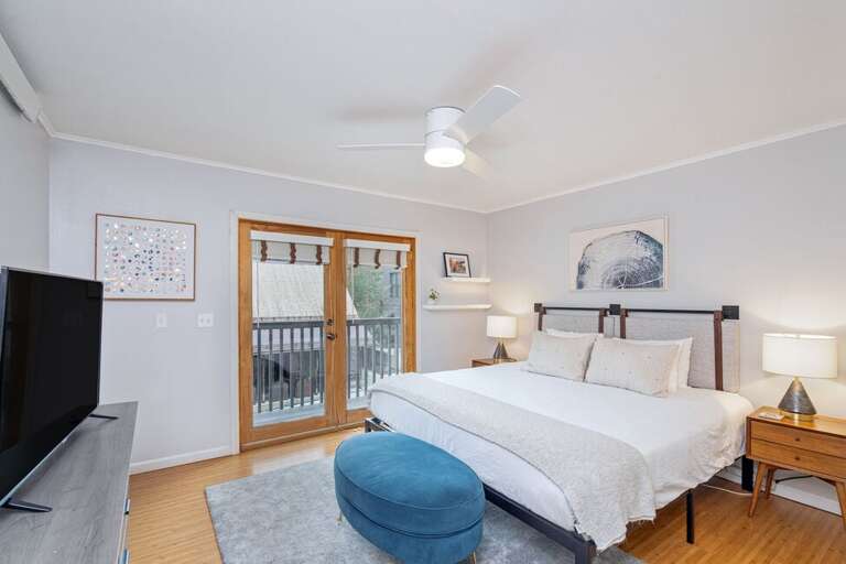 Entry level primary king bedroom with shared deck, TV, closet, views of town Entry level primary king bedroom with shared deck, TV, closet, views of town