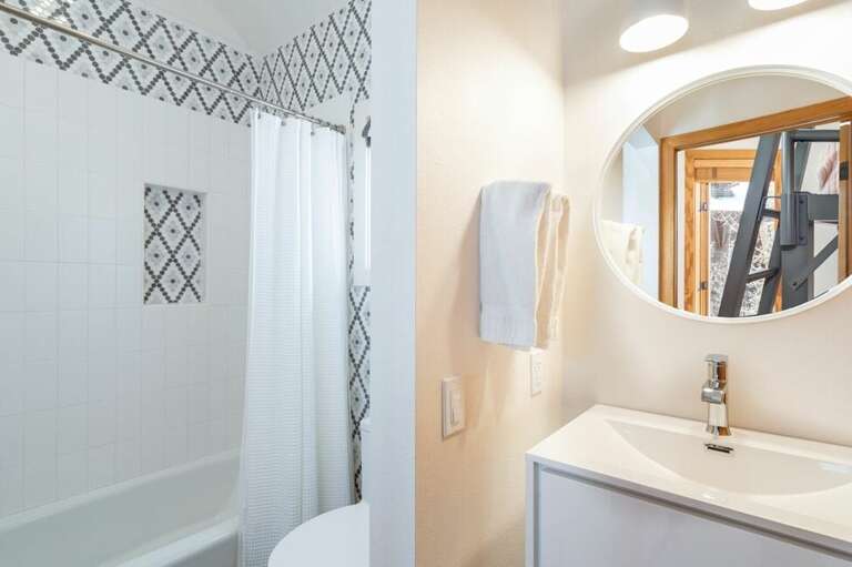 The en suite bathroom from the queen bunk room includes a shower and vanity. The en suite bathroom from the queen bunk room includes a shower and vanity.