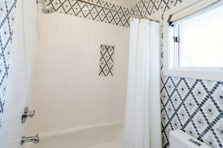 The en suite bathroom from the queen bunk room includes a shower and vanity. The en suite bathroom from the queen bunk room includes a shower and vanity.