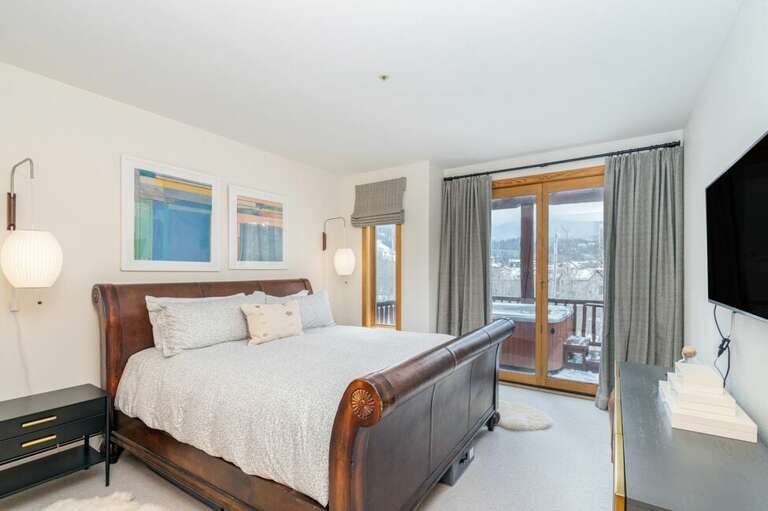 The king bedroom offers mountain vistas from the window, deck access, and a flat screen TV. The king bedroom offers mountain vistas from the window, deck access, and a flat screen TV.