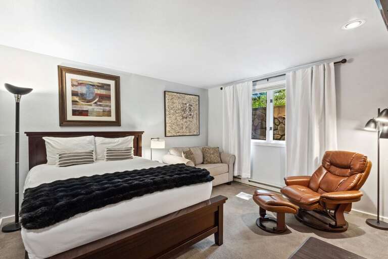 Cozy second room with a queen bed and small sleeper sofa.