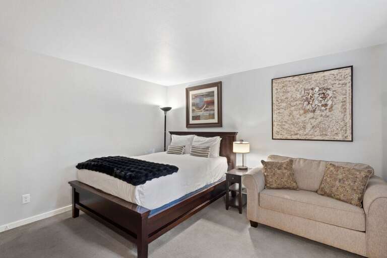 Guest queen bedroom with small sleeper sofa.