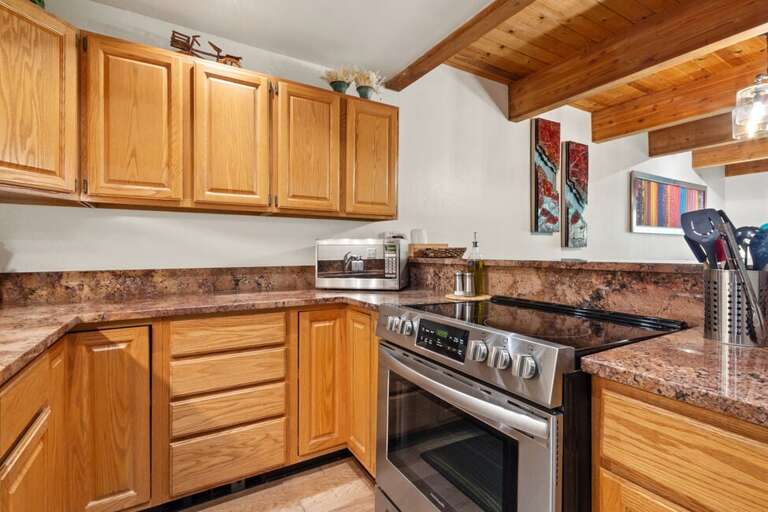 The kitchen is open plan with the living room and is well equipped for cooking family meals.