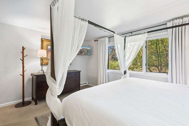 The primary king bedroom with river views.