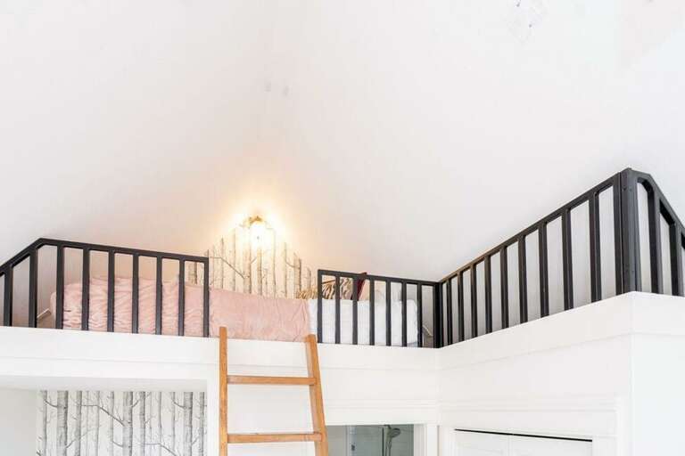 Access the queen bed loft via ladder from the master bedroom.