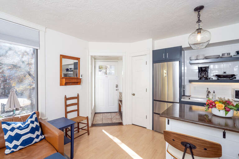 Enter this adorable space, there's a coat rack/bench on your left and into open space featuring the living area and kitchenette.