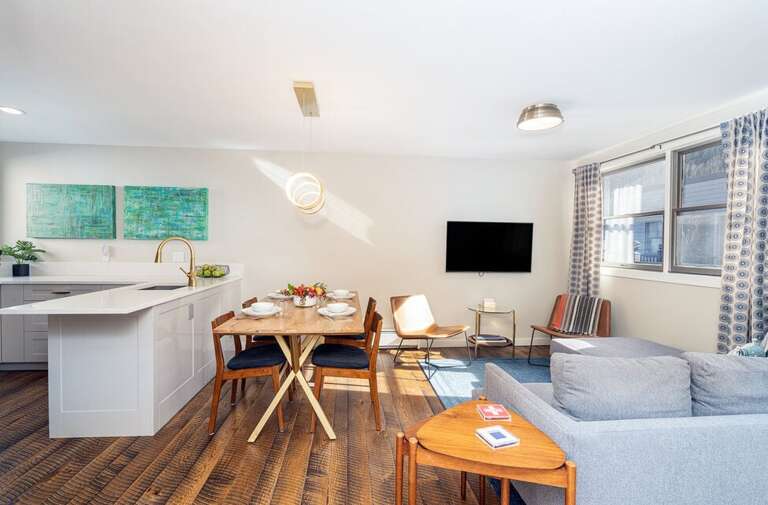 Open living room floor plan adjacent to kitchen for family gathering while cooking and lounging.