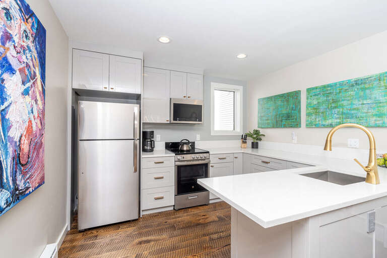 New stainless steel appliances and hard wood flooring.