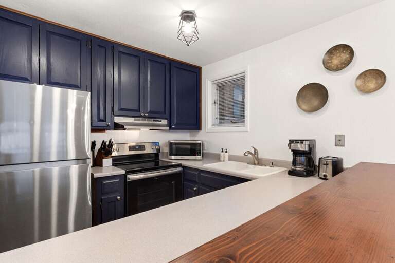 Galley kitchen is open to the living and dining area.