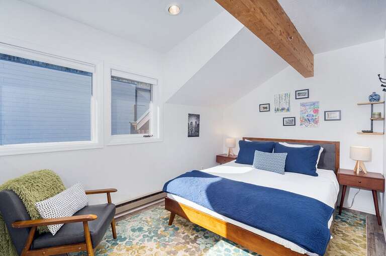 The loft space at the top of the spiral stairs features a queen bed. A privacy screen lets you close off the space a little more.