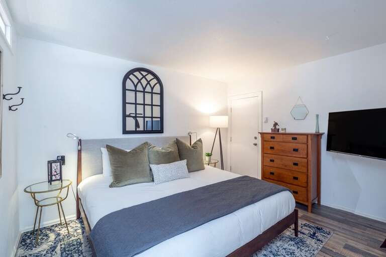 The master bedroom offers a king bed and flat screen TV.