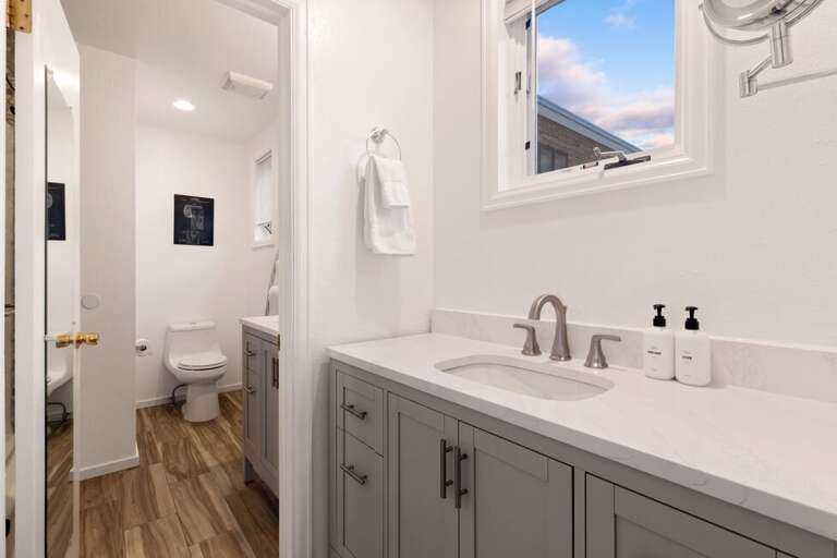 Water closet/shower room and vanity room are separated by a door giving privacy for guests.