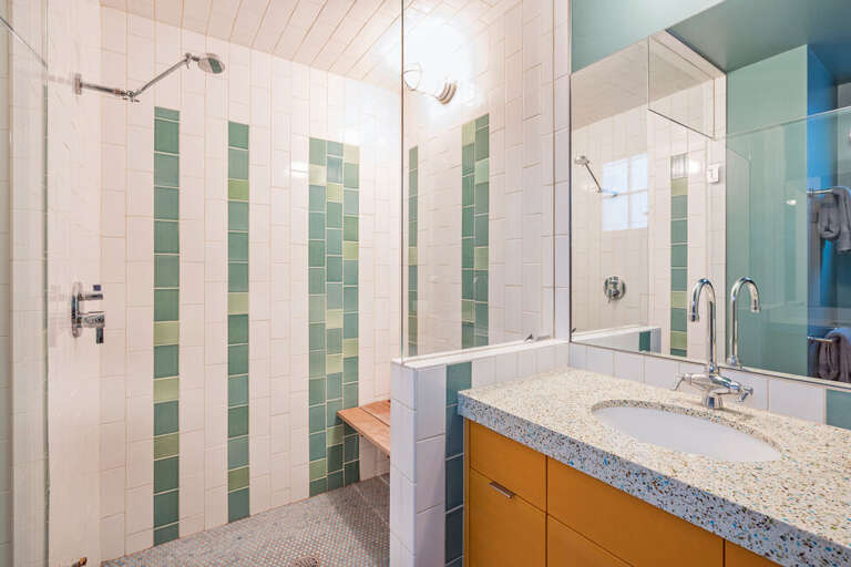 There is a large bathroom with shower on the main living level, near the kitchen.
