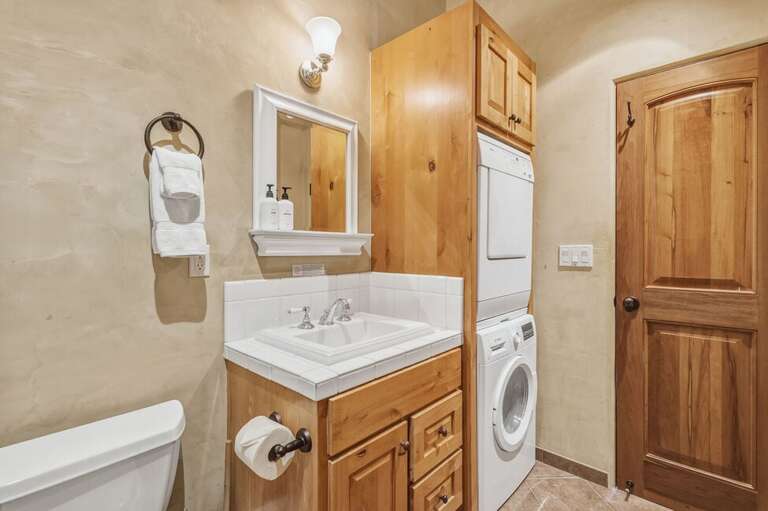 Bright and functional, the guest bathroom offers a walk-in shower plus in-unit washer and dryer for added convenience during your stay.