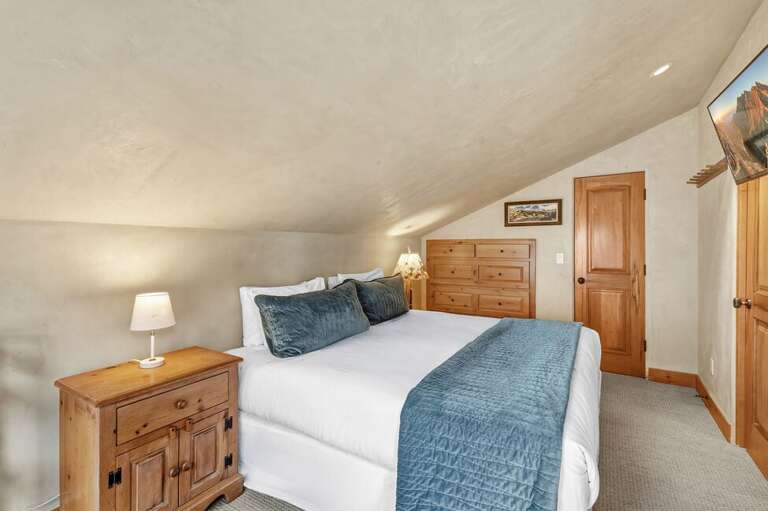 Cozy and inviting, the queen guest room provides a restful space after a day of adventure.