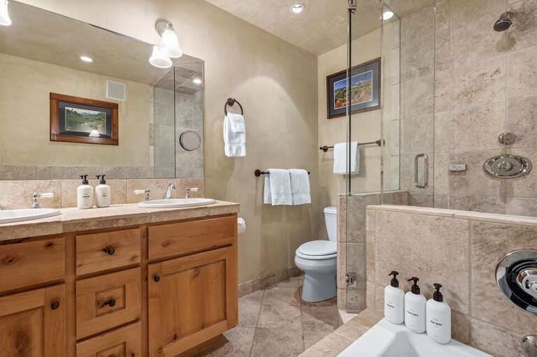 Enjoy a spa-like primary bathroom with a soaking tub and separate shower—ideal for relaxing after skiing or hiking.