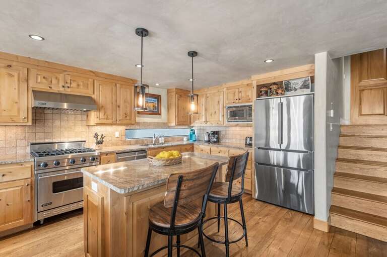Enjoy a spacious kitchen designed for groups, with a central island, bar seating, and everything needed to cook with ease.