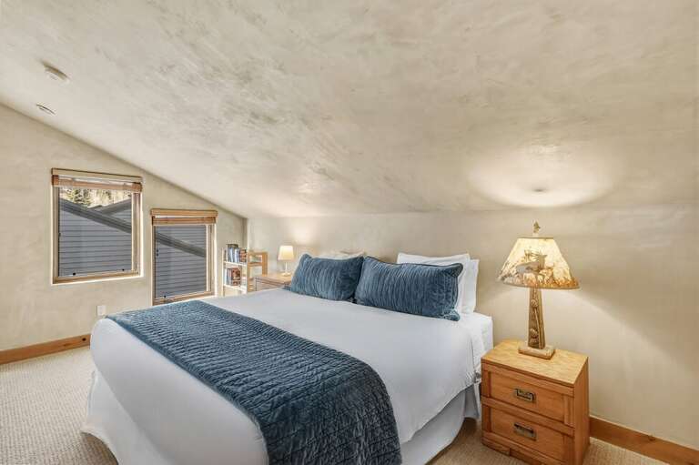 The guest bedroom offers a comfortable queen bed, perfect for couples or additional guests.