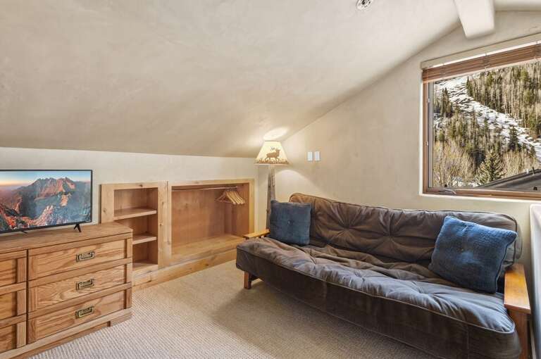 The loft adds versatile sleeping space with a captain's bunk and futon in an open, airy setting