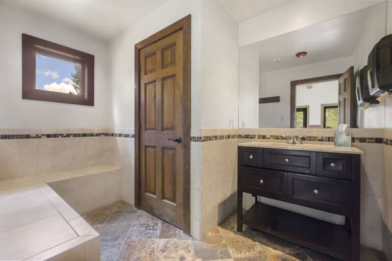 Indoor hot tub area with separate changing room/bathroom.