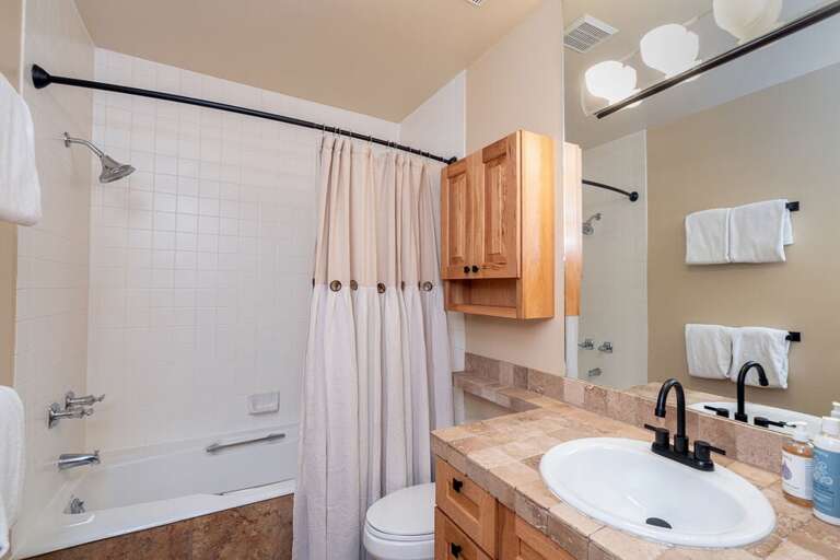 The first floor bathroom opens two ways to the Master Bedroom and to the common area.
