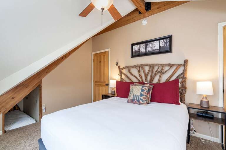 Second level queen bedroom featuring the nook for extra sleeping space.
