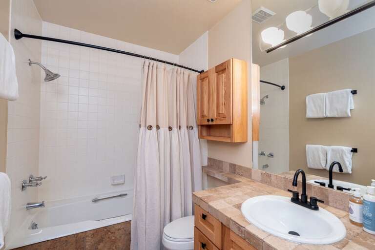 The bathroom on the main level has a combined shower and tub and includes a stackable washer/dryer.