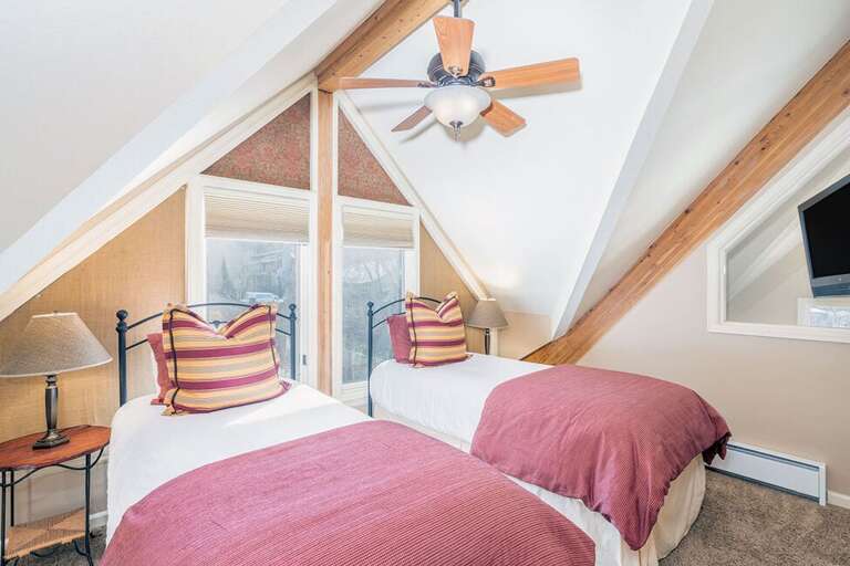 The twin bedroom upstairs overlooks the pool & hot tub area.