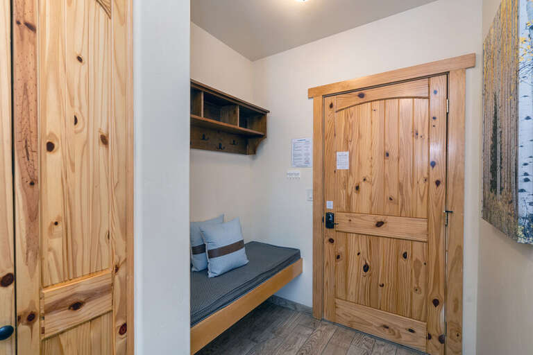 The entrance has a comfortable bench seat for putting on boots and plenty of storage for jackets and shoes.