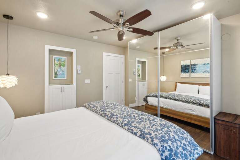 King bed with mirrored closet doors.